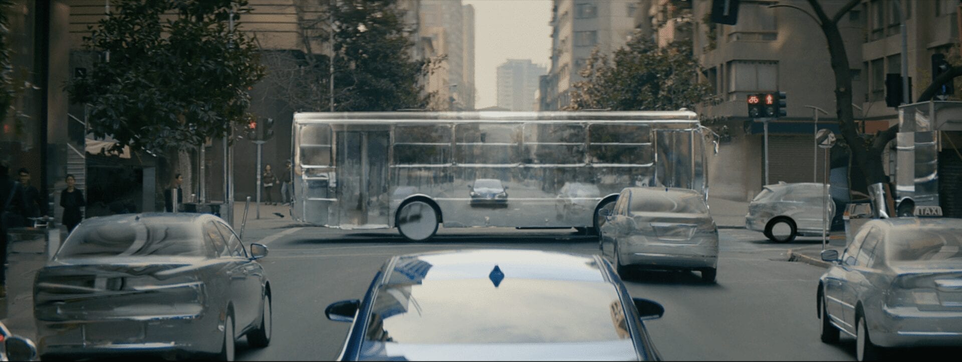 A car driving down the street with its windshield broken.
